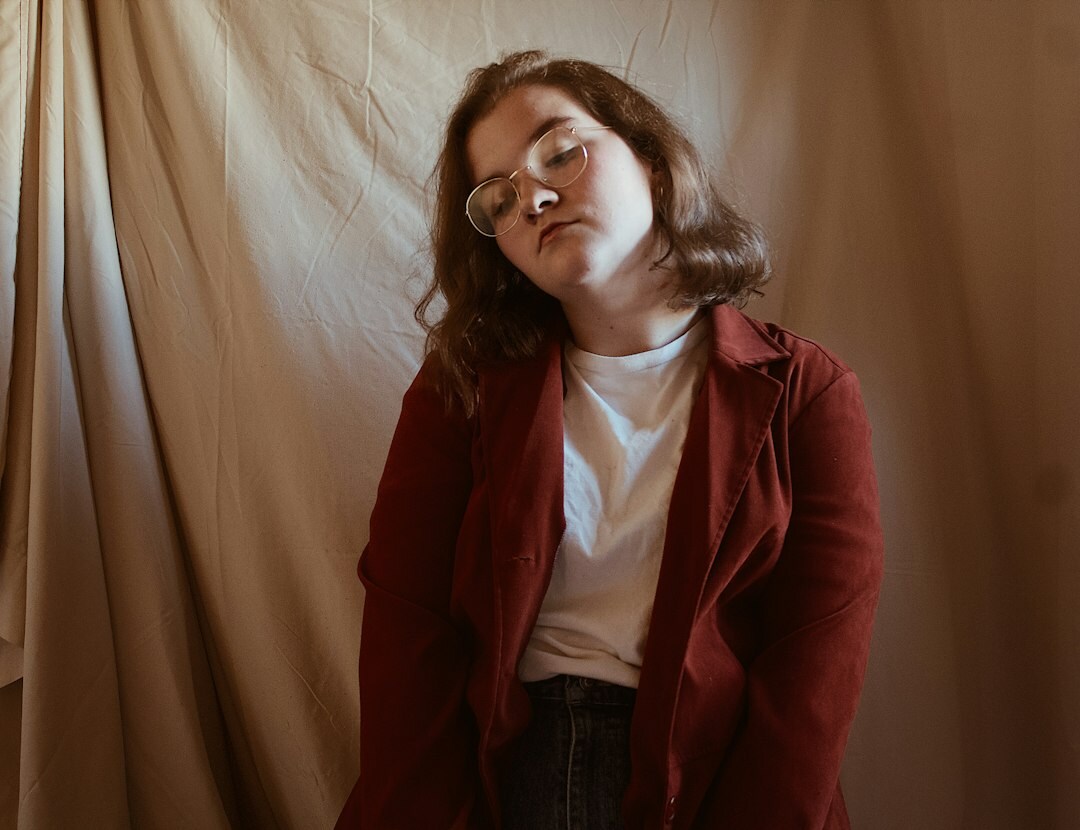 Studio portrait of a confident woman with short brown hair in a red blazer